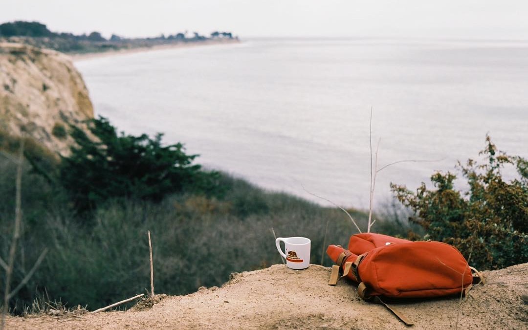 Cup of coffee overlooking the ocean. Photo by Kay Cheon